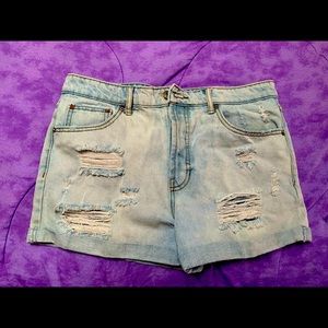 Light blue jeans with rips. button up no zipper